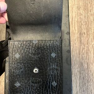MCM Visetos crossbody bag that can fit phone along with other items.